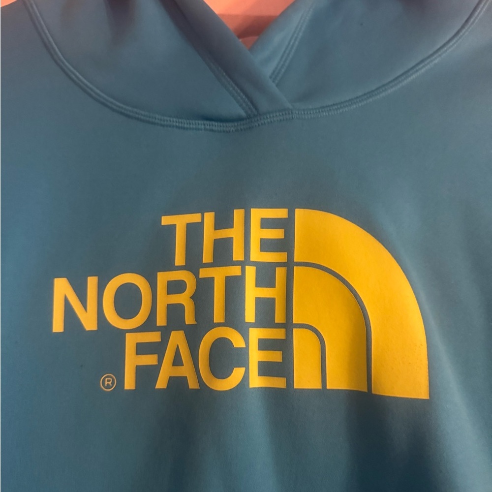 The North Face Teal Hoodie with Vibrant Yellow Logo